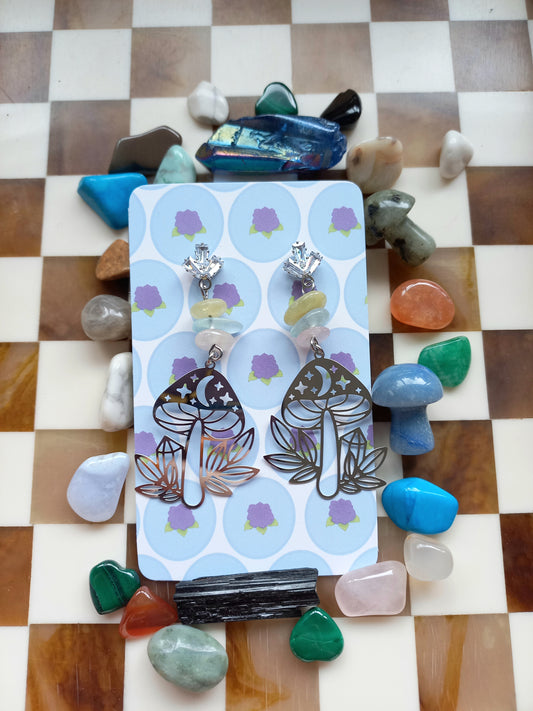 Earring set on a card with colorful stones on a checkered background